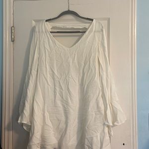 White fancy formal dress with an open back and long flowy sleeves